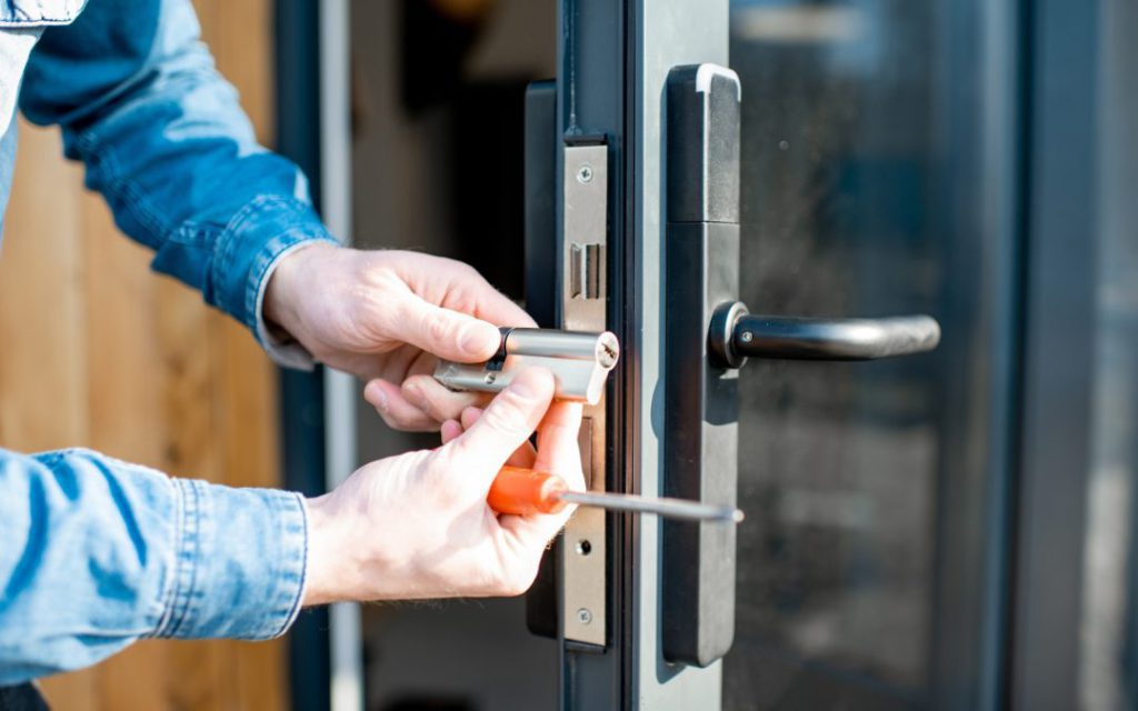 Homeowner performing lock maintenance tips on a front door lock