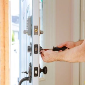 Homeowner performing lock maintenance tips on a front door lock
